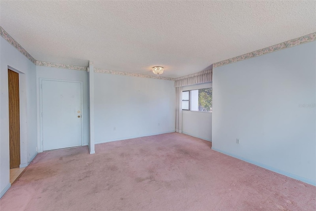 unfurnished room featuring light carpet and a textured ceiling