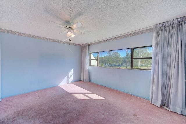 carpeted spare room featuring a textured ceiling and ceiling fan