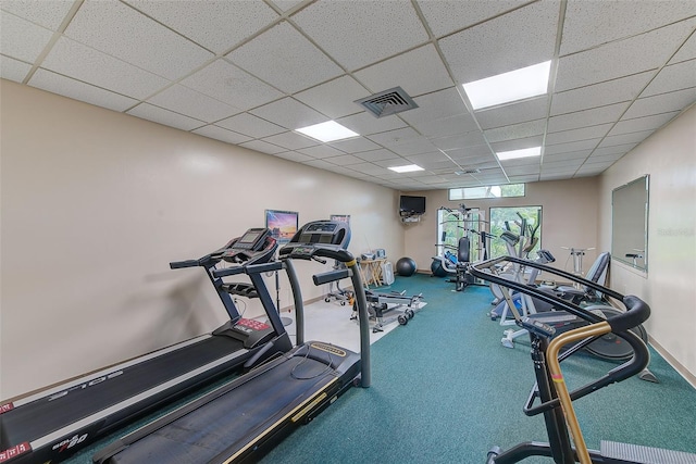 gym with a paneled ceiling