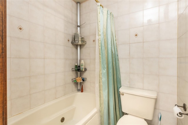 bathroom featuring shower / bath combo with shower curtain, tile walls, and toilet