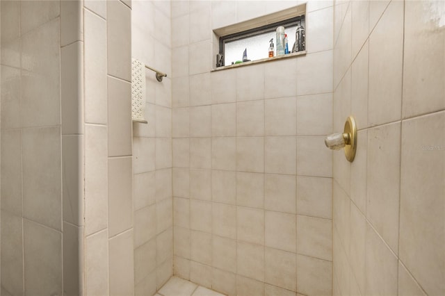 bathroom with a tile shower