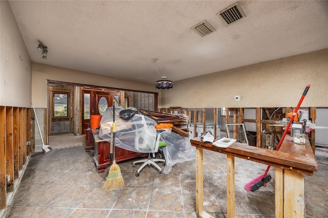 miscellaneous room featuring a textured ceiling