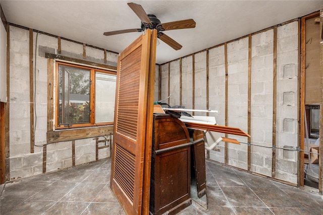 interior space with ceiling fan