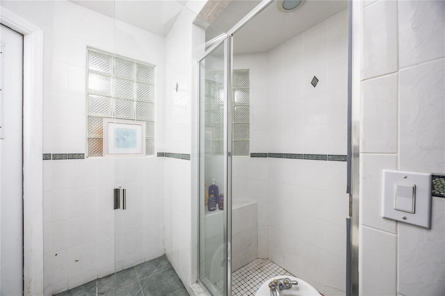 bathroom featuring a shower with door