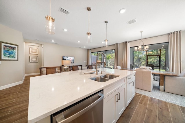 kitchen with a center island with sink, stainless steel dishwasher, wood-type flooring, and sink