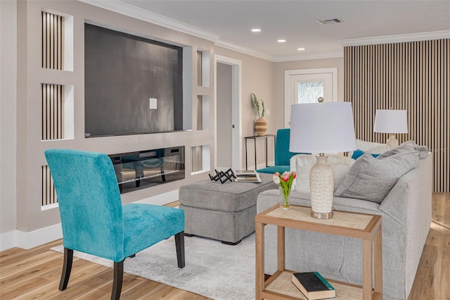 living room with crown molding and light hardwood / wood-style flooring