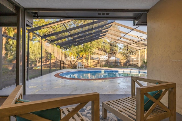 view of pool with a lanai and a patio