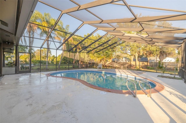 view of swimming pool with a lanai and a patio area