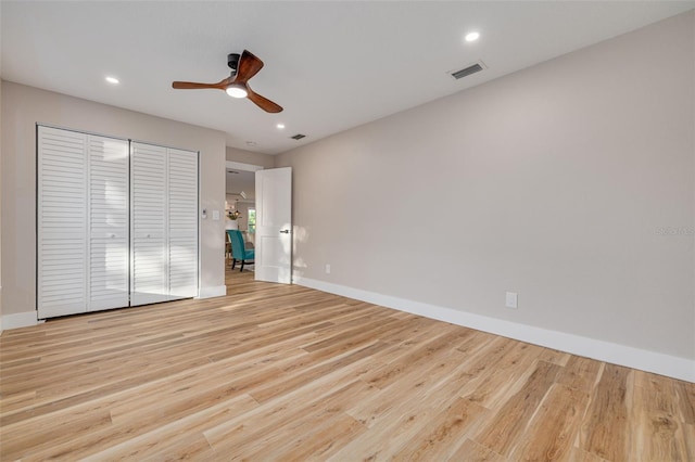 unfurnished room featuring ceiling fan and light wood-type flooring