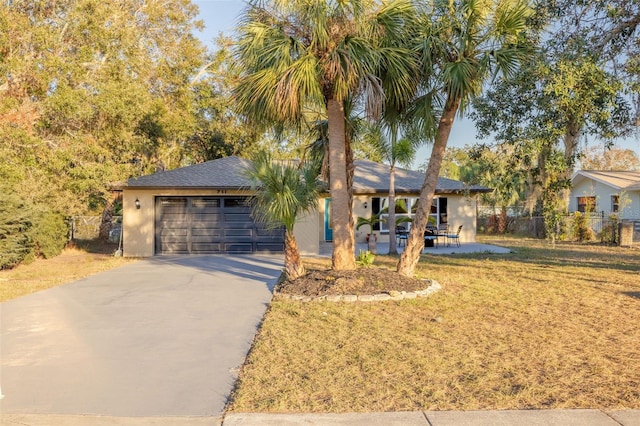 single story home featuring a garage and a front lawn