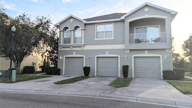 view of property featuring a balcony and a garage