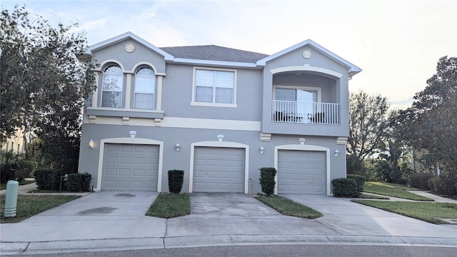 view of front of house with a garage and a balcony