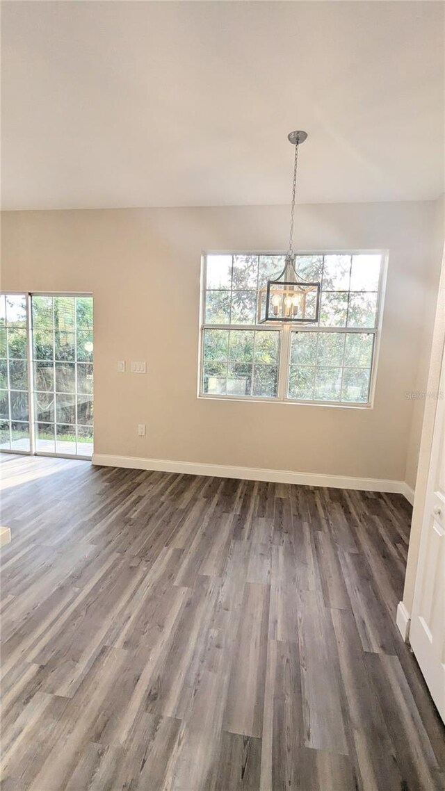 9060 Moonlit Meadows Loop, Riverview, FL 33578 - unfurnished dining area featuring dark wood-style flooring, a chandelier, and baseboards