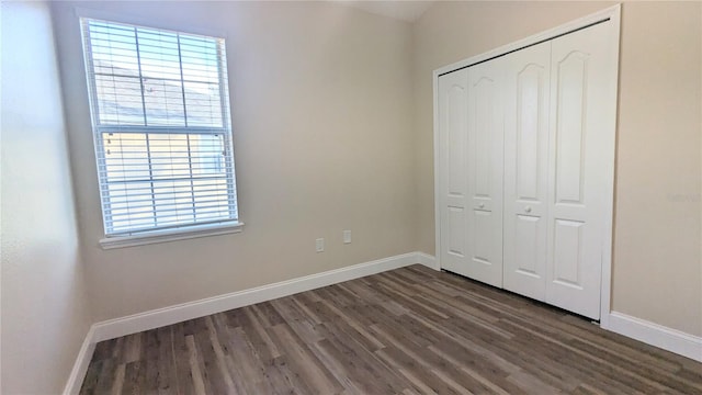 9060 Moonlit Meadows Loop, Riverview, FL 33578 - unfurnished bedroom with dark wood-style floors, baseboards, and multiple windows