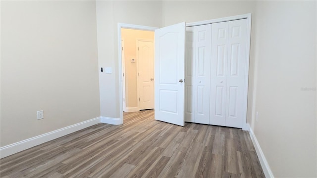 9060 Moonlit Meadows Loop, Riverview, FL 33578 - unfurnished bedroom featuring wood finished floors, a closet, and baseboards