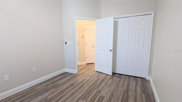 9060 Moonlit Meadows Loop, Riverview, FL 33578 - unfurnished bedroom featuring wood finished floors, baseboards, and a closet