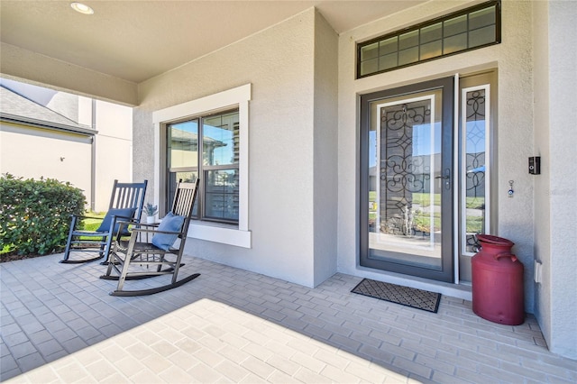 8144 Sequester Loop, Land O Lakes, FL 34637 - property entrance featuring stucco siding and covered porch