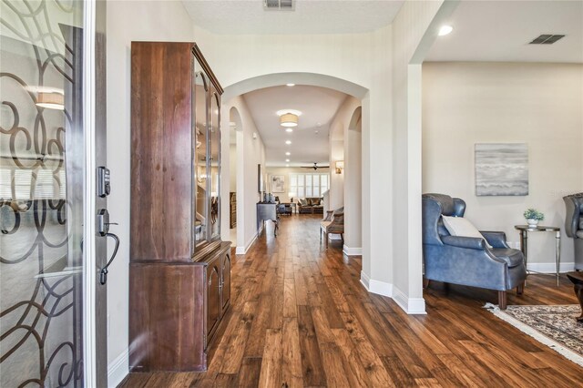 8144 Sequester Loop, Land O Lakes, FL 34637 - entryway with arched walkways, dark wood-style flooring, and baseboards