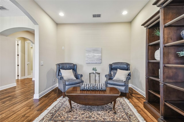 sitting room with dark wood-type flooring