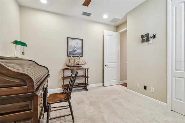 living area with light carpet and ceiling fan