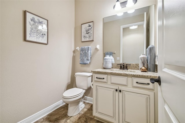 bathroom with tile patterned flooring, vanity, and toilet