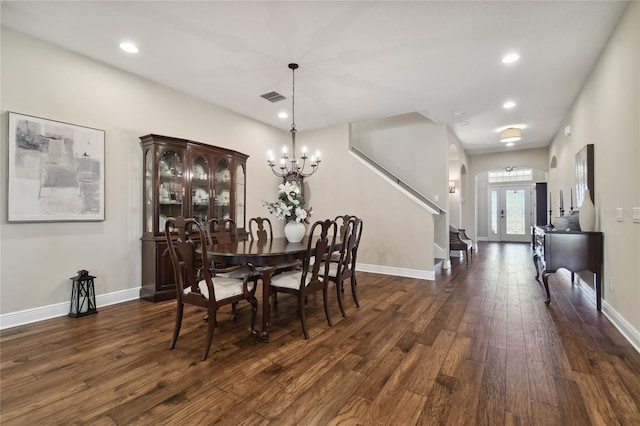 dining area featuring a notable chandelier, dark hardwood / wood-style floors, and french doors