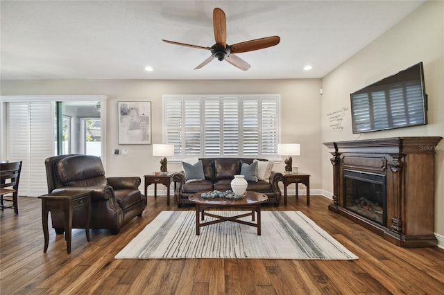 living room featuring ceiling fan and dark hardwood / wood-style flooring