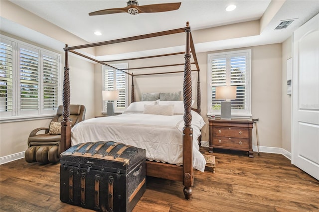 bedroom with dark hardwood / wood-style floors and ceiling fan