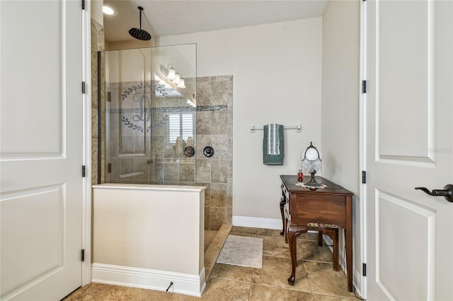 bathroom featuring tiled shower and a textured ceiling