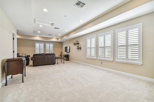 living room featuring light colored carpet and a textured ceiling