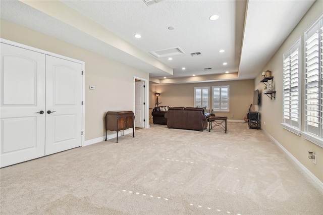 carpeted living room featuring a textured ceiling