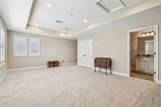8144 Sequester Loop, Land O Lakes, FL 34637 - unfurnished bedroom featuring carpet floors, attic access, recessed lighting, baseboards, and a tray ceiling
