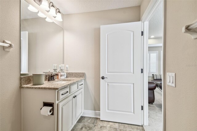 bathroom featuring vanity and a textured ceiling