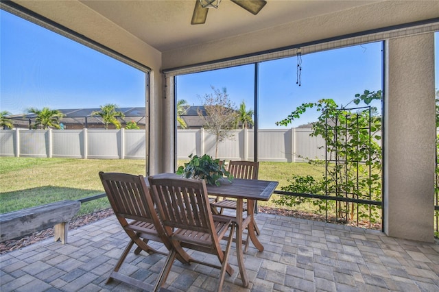 sunroom featuring ceiling fan