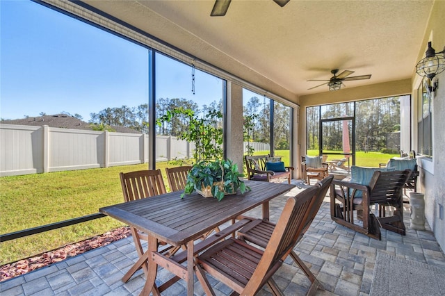 sunroom featuring ceiling fan