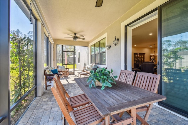 sunroom featuring ceiling fan