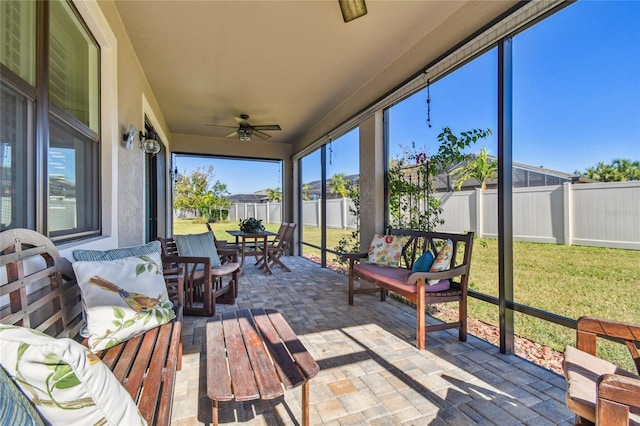 sunroom / solarium featuring ceiling fan