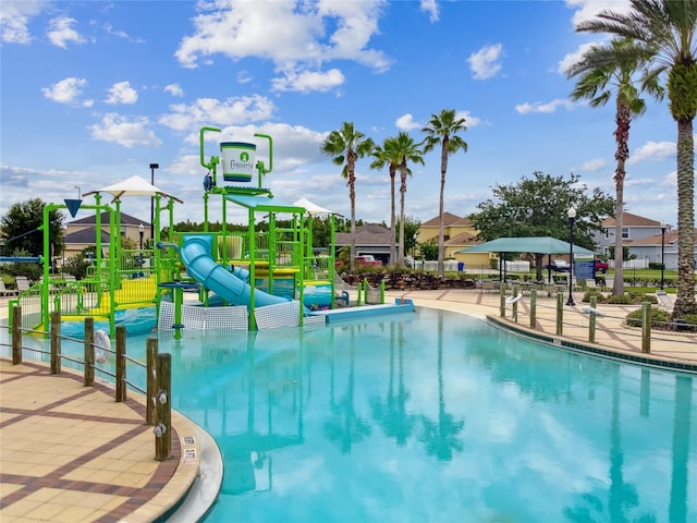 view of pool with a playground and a water slide