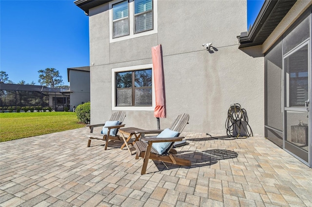 view of patio / terrace featuring glass enclosure