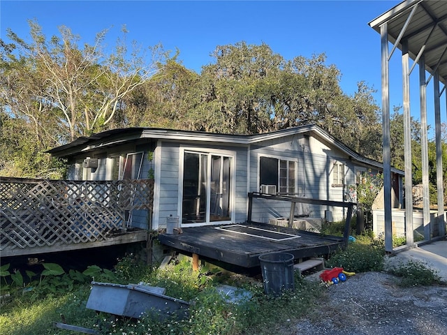 rear view of house with a wooden deck