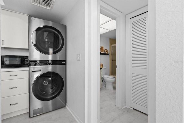 washroom with stacked washer / drying machine