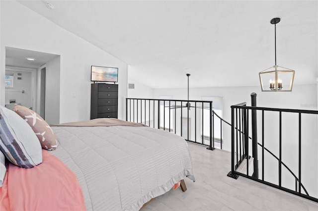 bedroom with a notable chandelier and vaulted ceiling