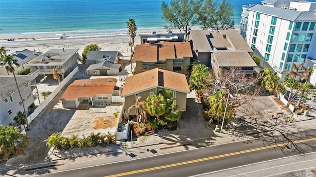 aerial view with a water view and a beach view