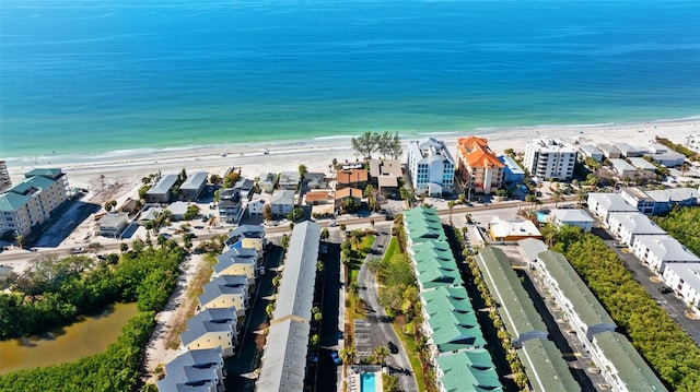 drone / aerial view featuring a beach view and a water view