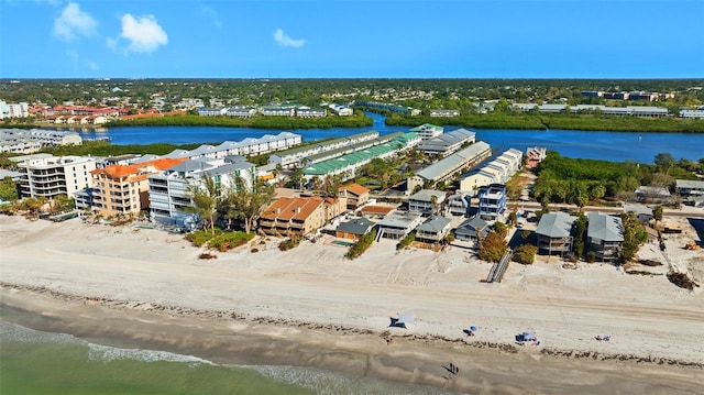 aerial view with a water view and a beach view