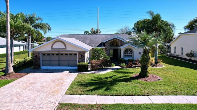 ranch-style home with a garage and a front lawn