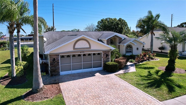 ranch-style house featuring a front yard and a garage