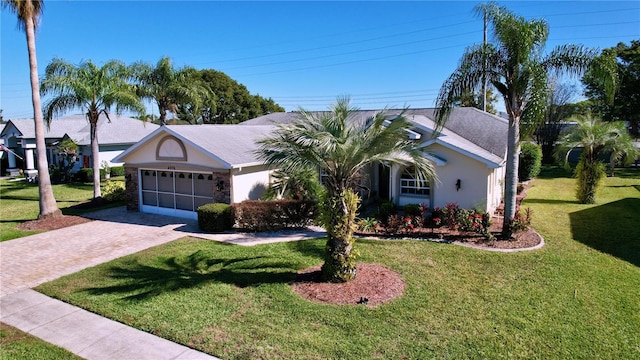 single story home featuring a front lawn and a garage