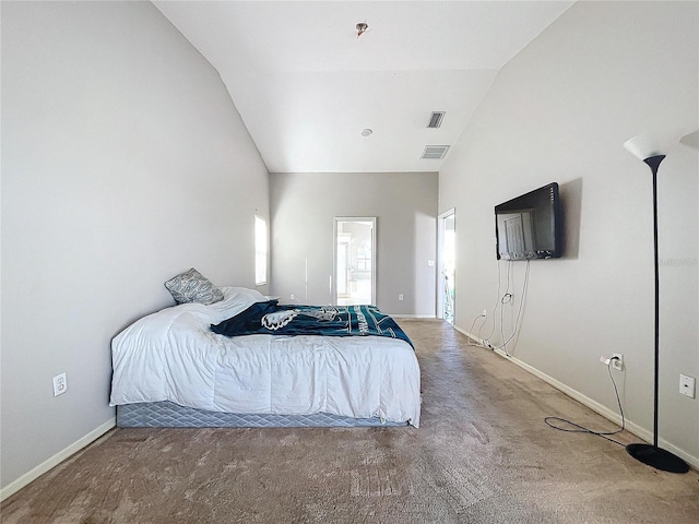 carpeted bedroom with lofted ceiling