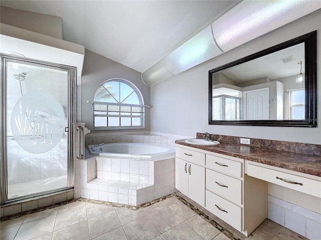 bathroom with tile patterned floors, vanity, vaulted ceiling, and independent shower and bath